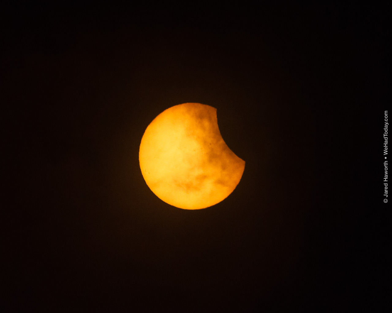 First contact (C1) was hidden behind clouds and rain at our location (Shaw AFB), this was the first clear photo of the partial phase of the eclipse, as the clouds were clearing.