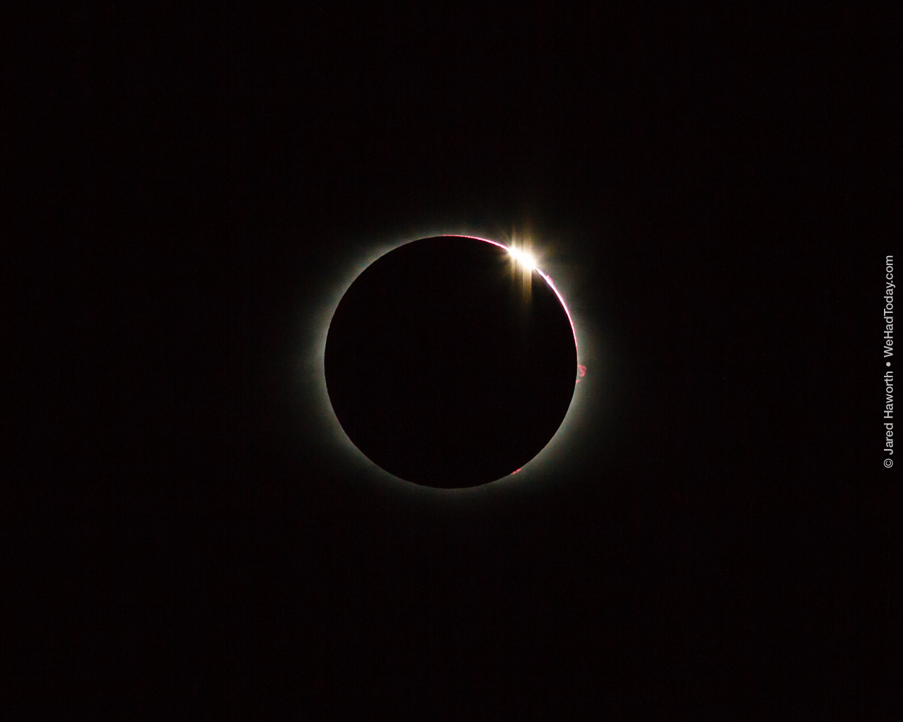 The second of the "diamond ring" phases of totality, as the moon begins to clear the face of the sun.