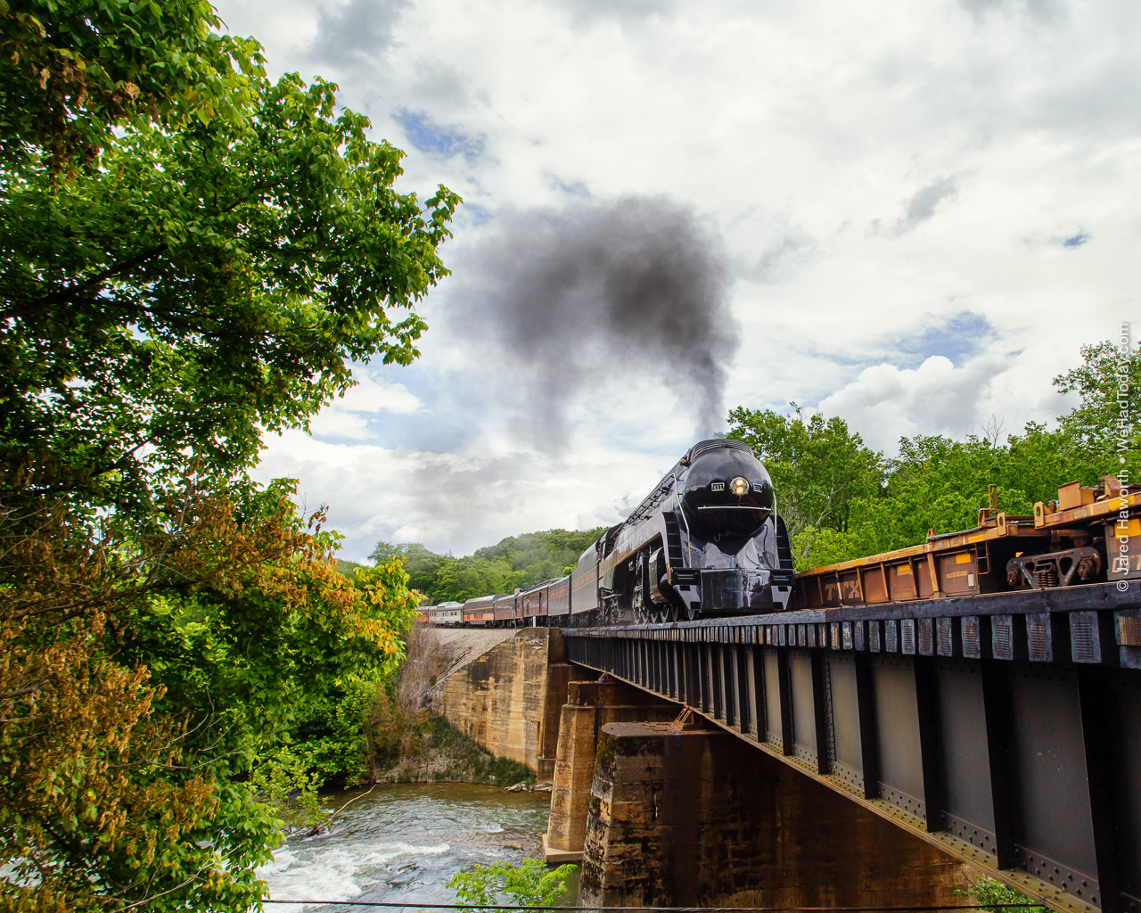 West of Salem, the N&W tracks cross over the Roanoke River, and the 611 paces a westbound containerized freight train.  Luckily, just as the steam train pulled around the corner, she met a series of empty well cars, leaving us with a more or less unobstructed background.