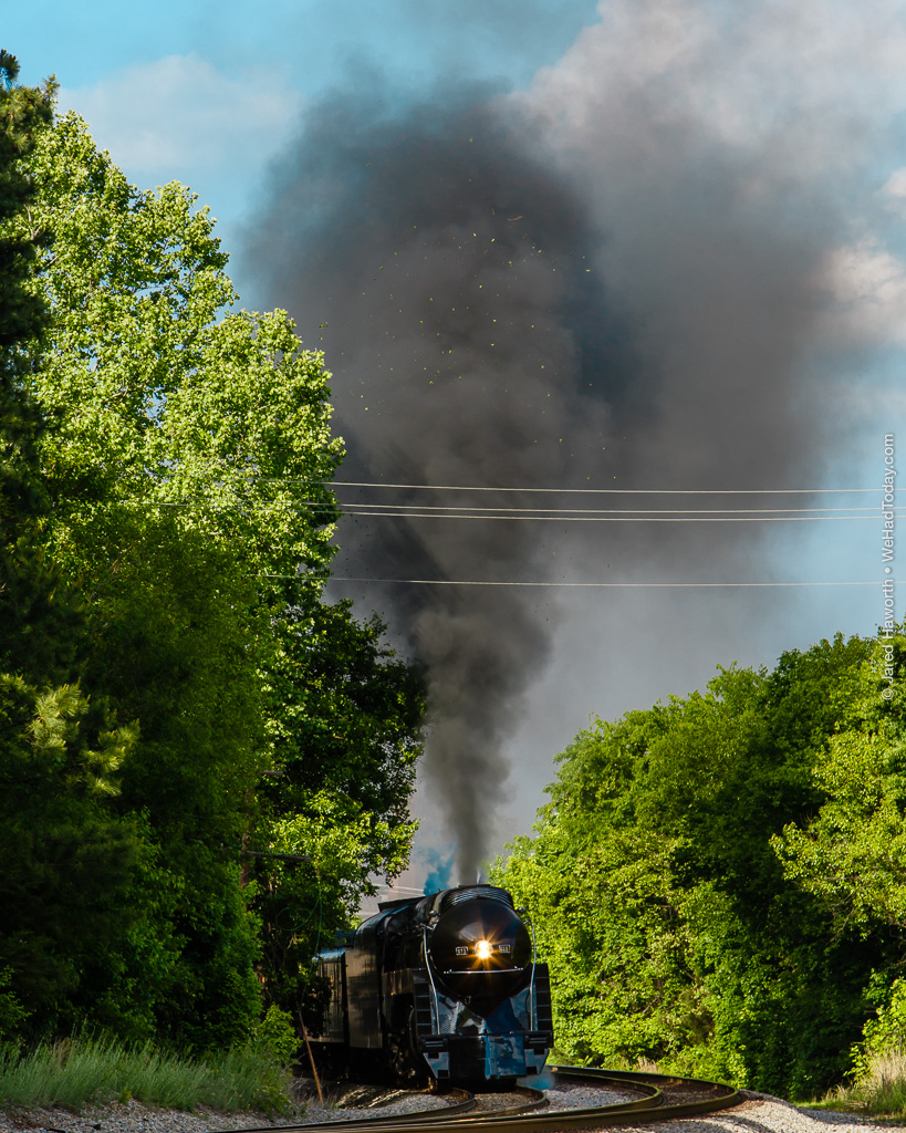 The power of 611's steam boiler blasts leaves & twigs off the overhanging boughs of trees in Blackstone, VA.