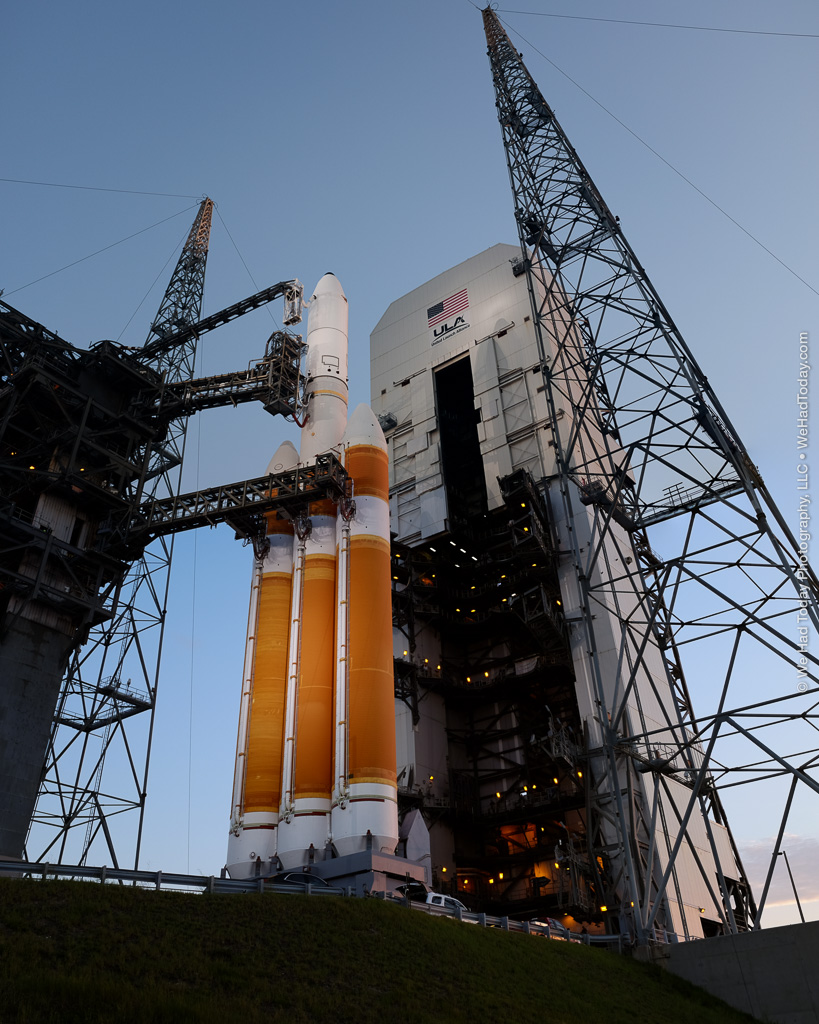 The Delta IV Heavy emerges from the mobile service tower, as the latter rolls back from the launchpad.
