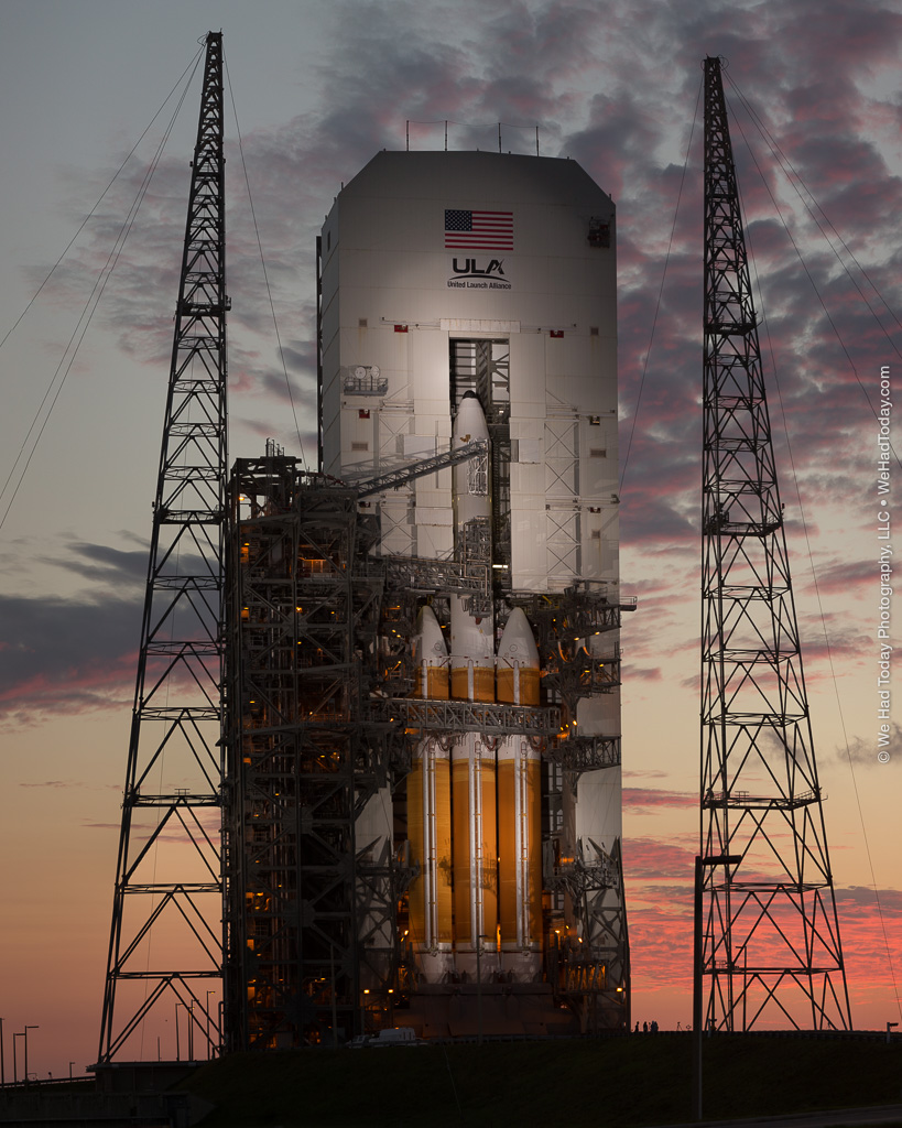 United Launch Alliance's Delta IV Heavy rocket, lit by xenon spotlights as the sun rises behind SLC-37B.