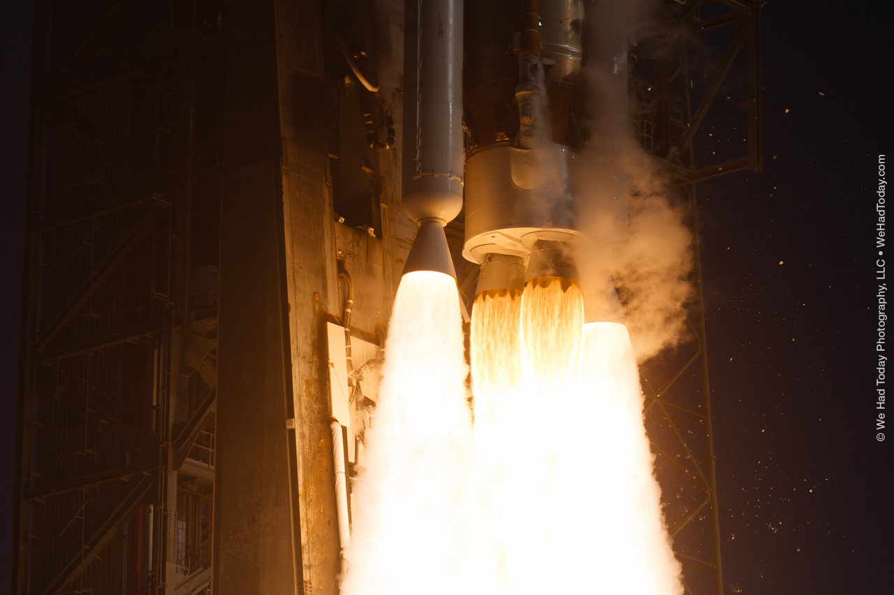 The RD-180 main engine is flanked by a pair of AJ-60A solid rocket boosters in this launch closeup image.