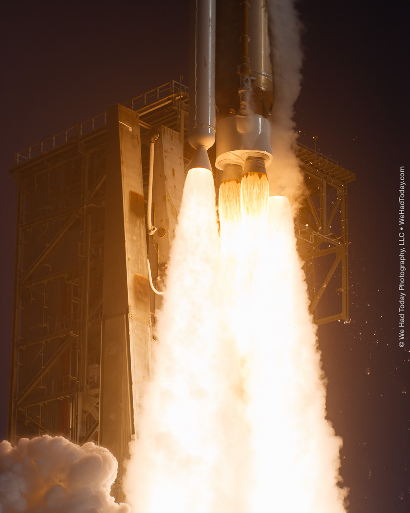 The RD-180 main engine is flanked by a pair of AJ-60A solid rocket boosters in this launch closeup image.