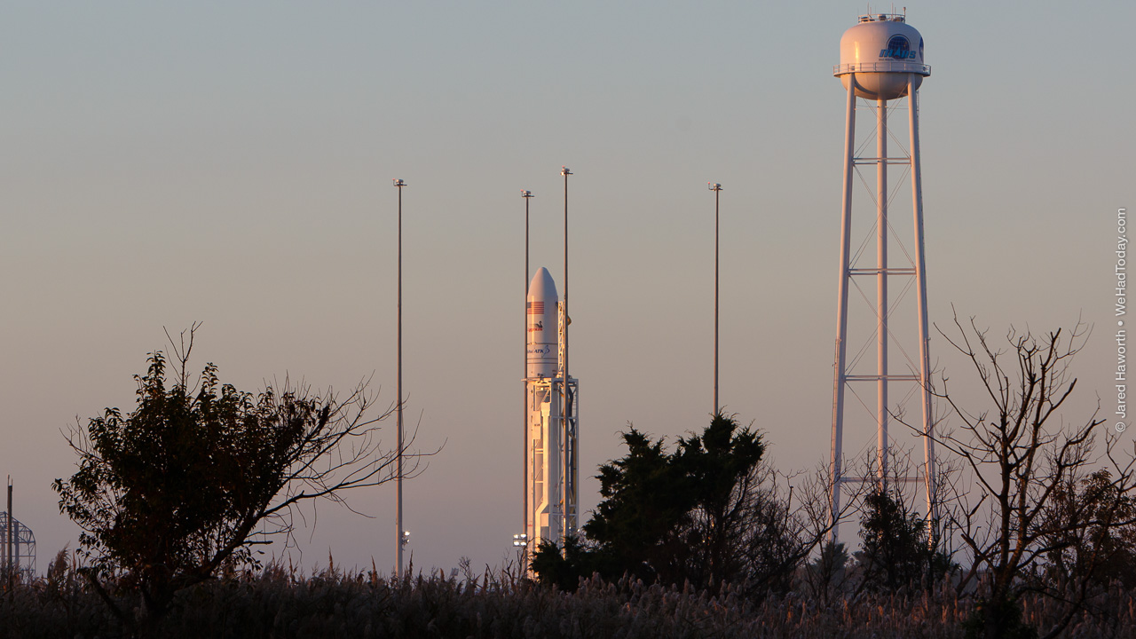 The first rays of the rising sun illuminate the Antares launch vehicle.  Photo credit: Jared Haworth / We Report Space