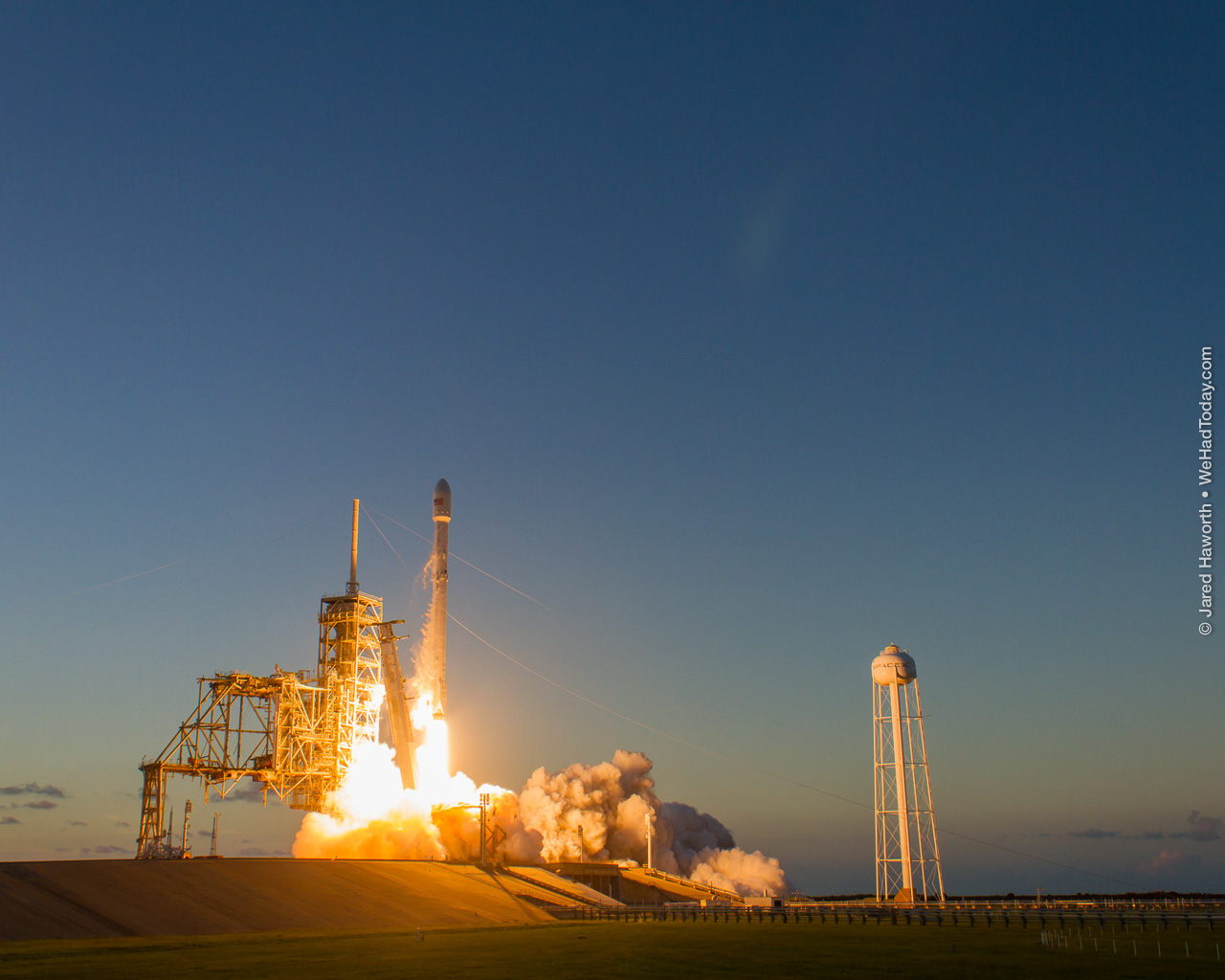 SpaceX's flight proven Falcon 9 begins its climb to orbit.  Photo credit: Jared Haworth / We Report Space